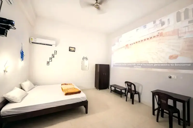 Room 3 with one king-size bed and projector wall