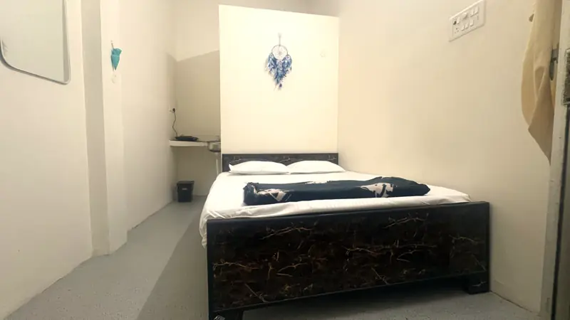 Room 1 bed with carved headboard